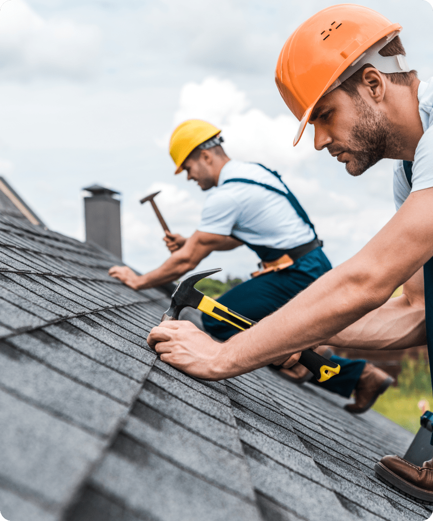 Workers inspecting shingle roof