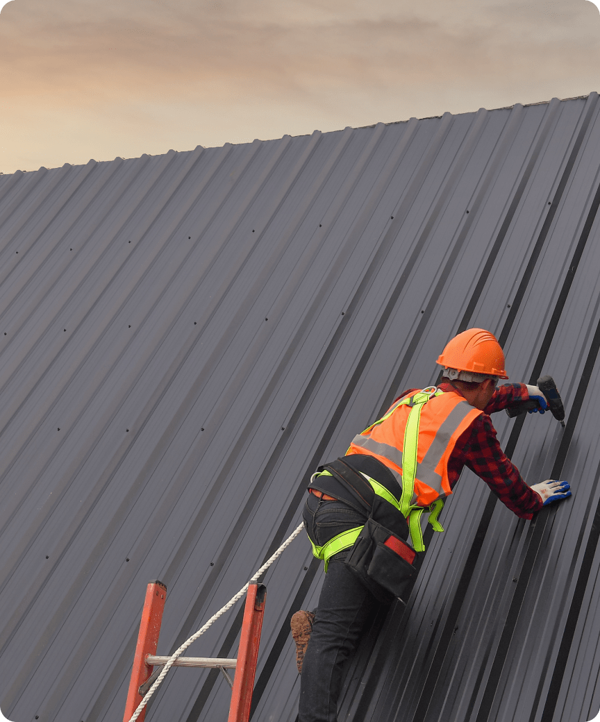 Worker inspecting metal roof