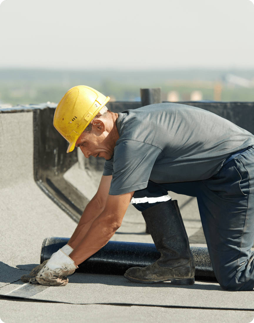 Worker inspecting flat roof